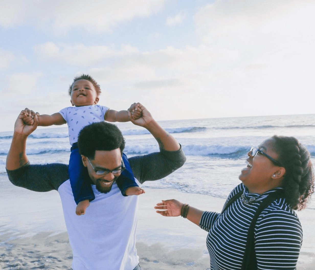 happy parents at beach with child