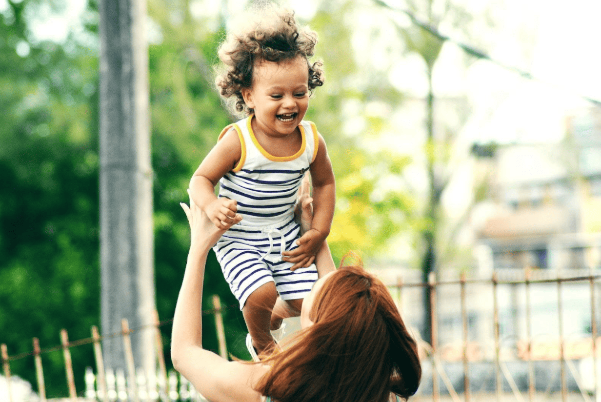 mother playing with happy child