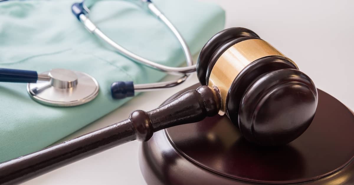 a stethoscope and gavel rest on a table | The Bishop Law Group
