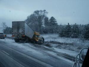 A commercial truck crashed on the side of the road in the snow. Who is liable for commercial truck accidents?