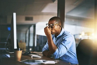 A stressed man at his desk, wondering about the consequences of DIY legal cases and mistakes to avoid.